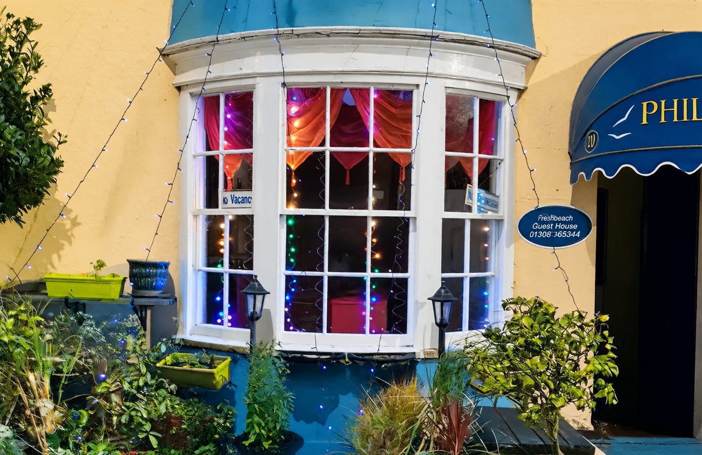 The Philbeach bay window lit up at night